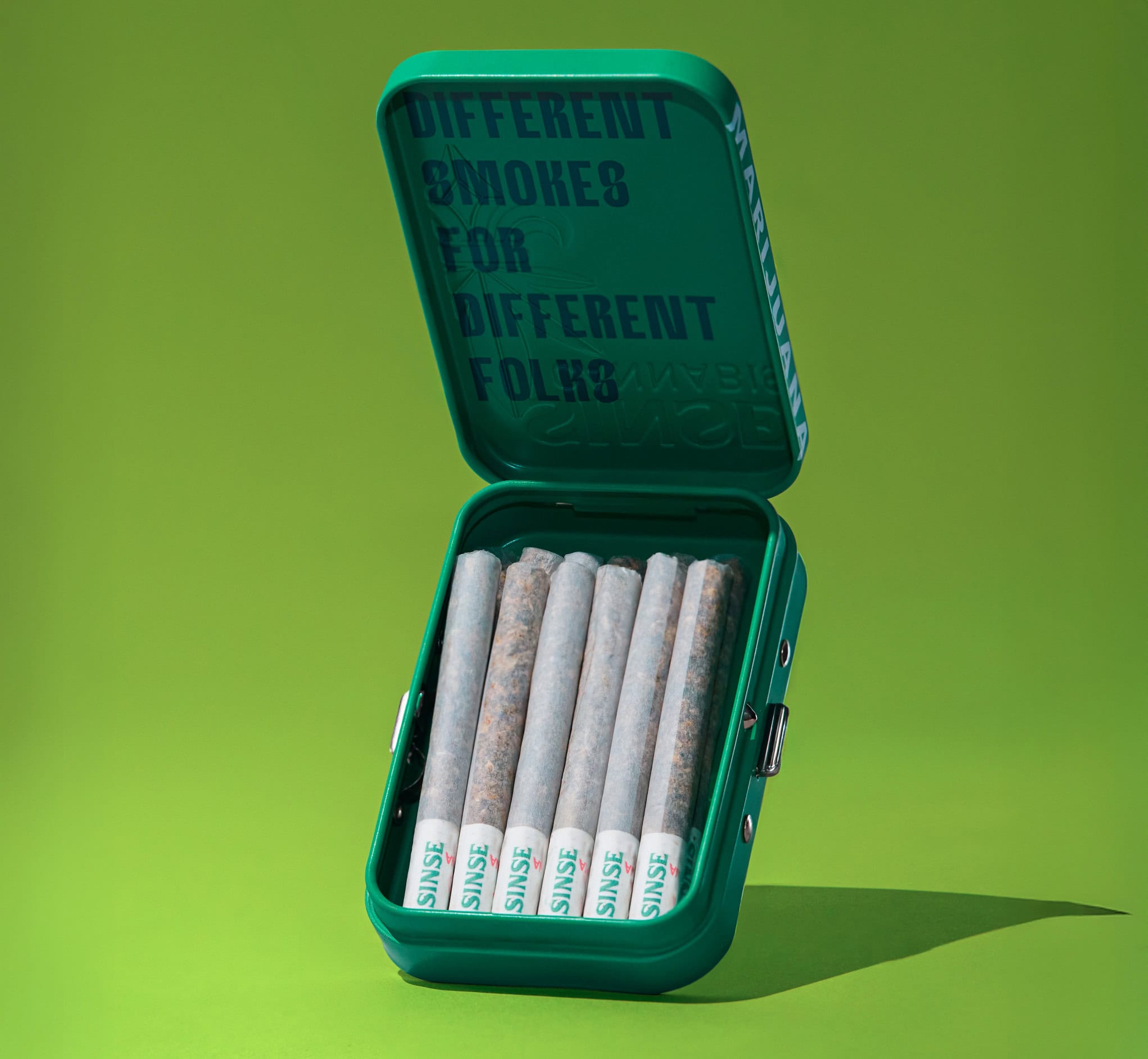 Pre-rolls cannabis pack in green case with message inside lid.