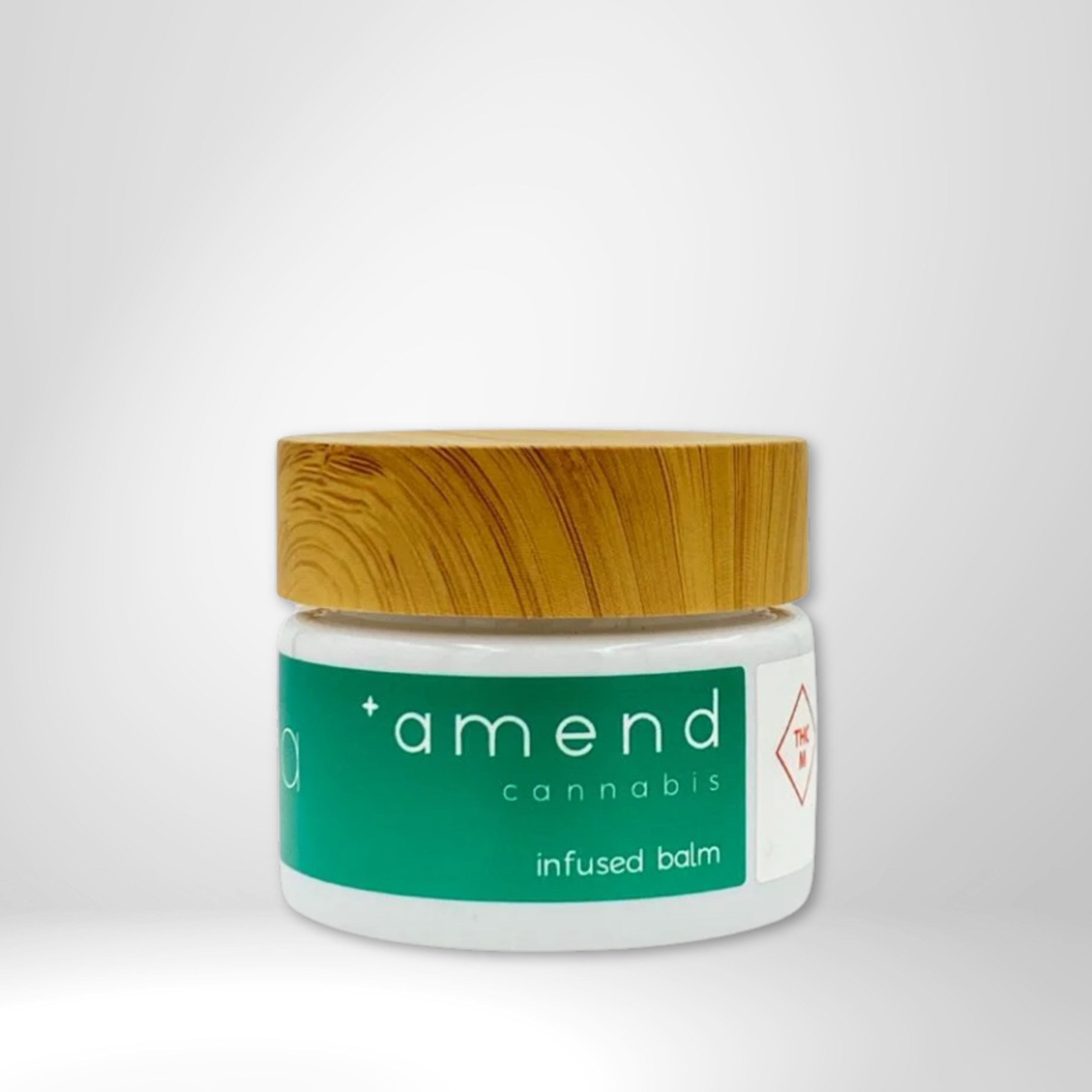 Amend Cannabis infused balm jar with wooden lid for skin relief.
