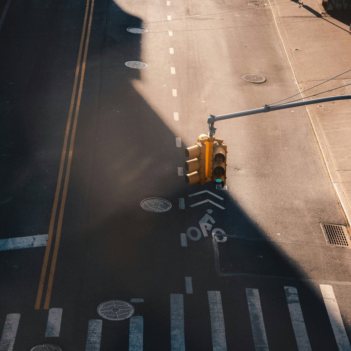 Empty city street with traffic light and crosswalks in Manhattan.